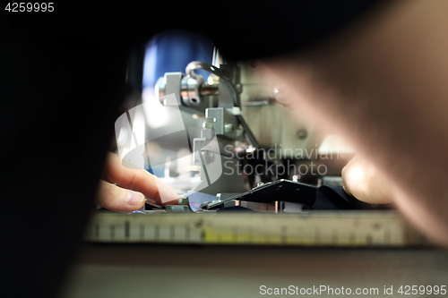 Image of Production of clothes, sewing on a machine