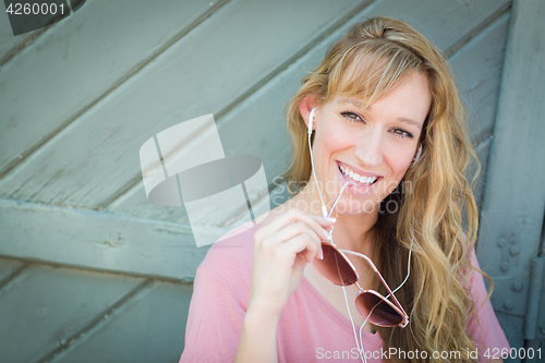 Image of Outdoor Portrait of Young Adult Brown Eyed Woman With Sunglasses