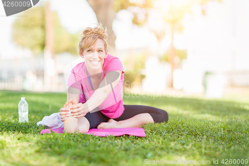 Image of Young Fit Flexible Adult Woman Outdoors on The Grass With Yoga M