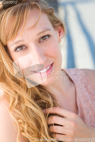 Image of Outdoor Portrait of Young Adult Brown Eyed Woman.