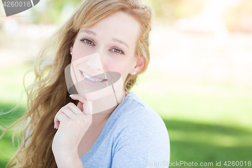 Image of Outdoor Portrait of Young Adult Brown Eyed Woman.