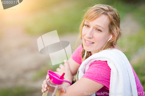 Image of Young Fit Adult Woman Outdoors With Towel and Water Bottle in Wo