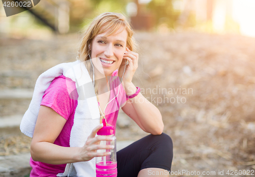 Image of Young Fit Adult Woman Outdoors With Towel and Water Bottle in Wo