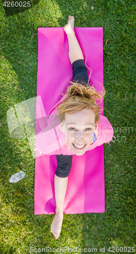Image of Overhead of Young Fit Flexible Adult Woman Outdoors on The Grass
