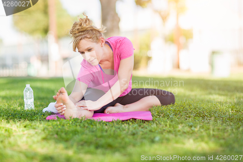 Image of Young Fit Flexible Adult Woman Outdoors on The Grass With Yoga M