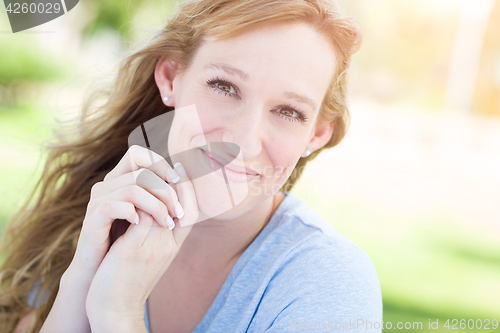 Image of Outdoor Portrait of Young Adult Brown Eyed Woman.