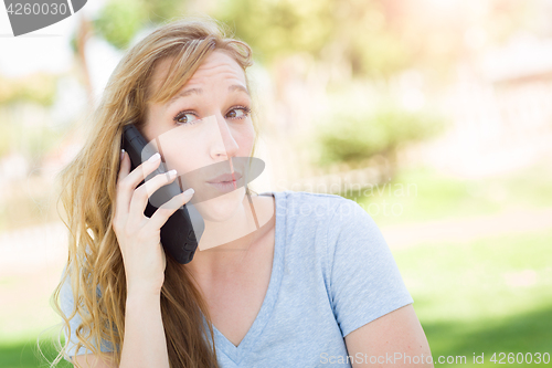 Image of Young Adult Woman Outdoors Talking on Her Smart Phone.