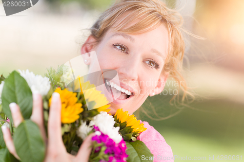 Image of Outdoor Portrait of an Excited Young Adult Brown Eyed Woman Hold
