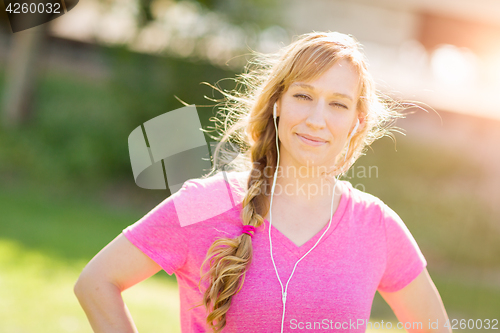 Image of Young Fit Adult Woman Outdoors Workout Clothes Listening To Musi