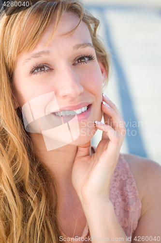Image of Outdoor Portrait of Young Adult Brown Eyed Woman.