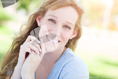 Image of Outdoor Portrait of Young Adult Brown Eyed Woman.