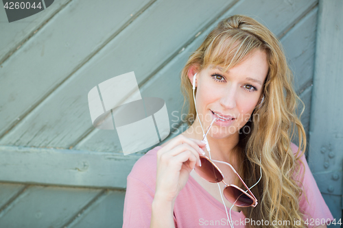 Image of Outdoor Portrait of Young Adult Brown Eyed Woman With Sunglasses