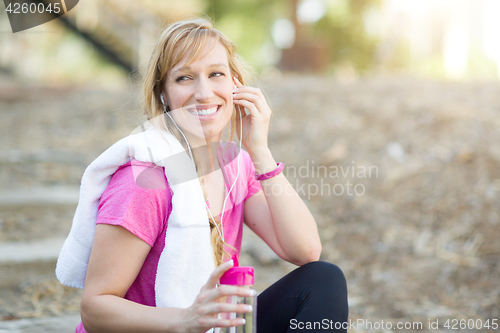 Image of Young Fit Adult Woman Outdoors With Towel and Water Bottle in Wo