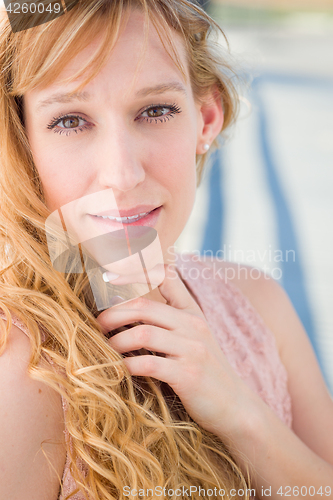 Image of Outdoor Portrait of Young Adult Brown Eyed Woman.