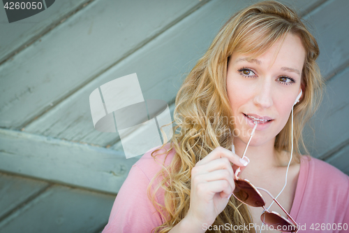 Image of Outdoor Portrait of Young Adult Brown Eyed Woman With Sunglasses