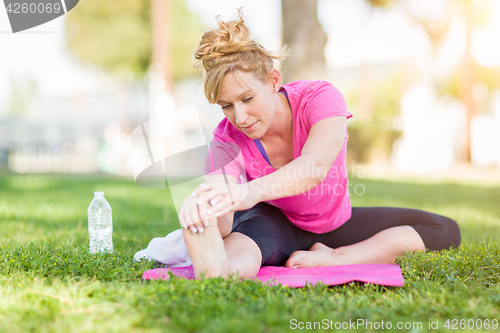 Image of Young Fit Flexible Adult Woman Outdoors on The Grass With Yoga M