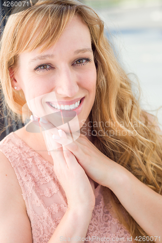 Image of Outdoor Portrait of Young Adult Brown Eyed Woman.