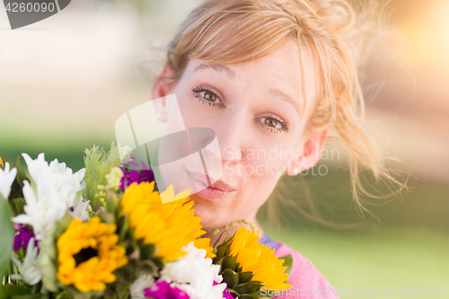 Image of Outdoor Portrait of an Excited Young Adult Brown Eyed Woman Hold