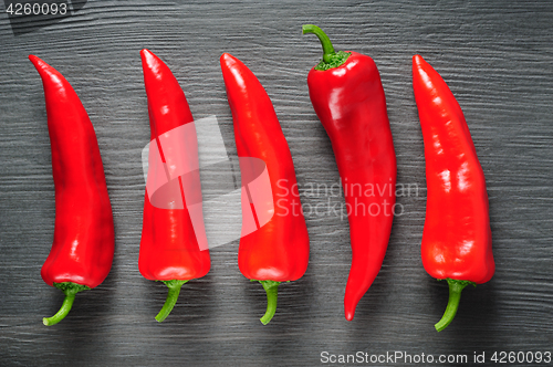 Image of Sweet red Kapia peppers on a dark shale stone background