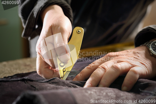 Image of Furrier cut leather sewing scum Cutting mink fur