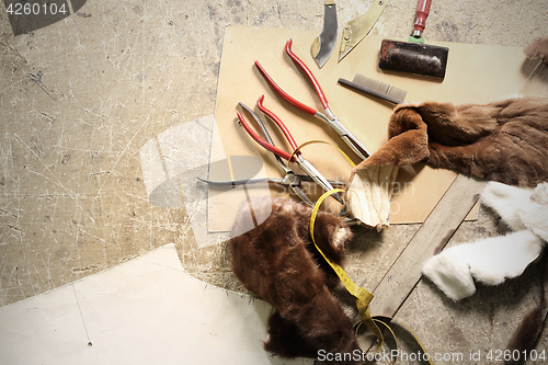 Image of Natural fur tailor made workshop furrier. A tailor, leather craft