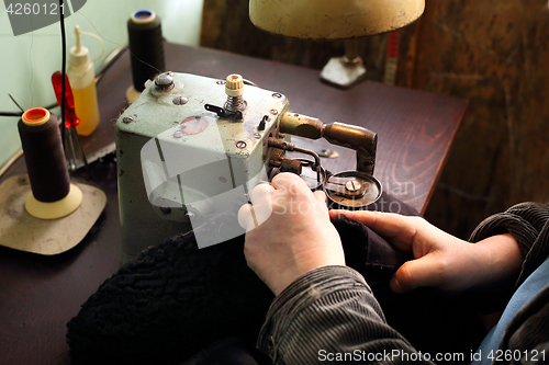 Image of Furrier at the factory in the neck fur coat