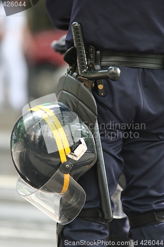 Image of Helmet and truncheon on a police officer in the street