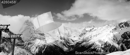 Image of Black and white panoramic view on snow mountains in clouds