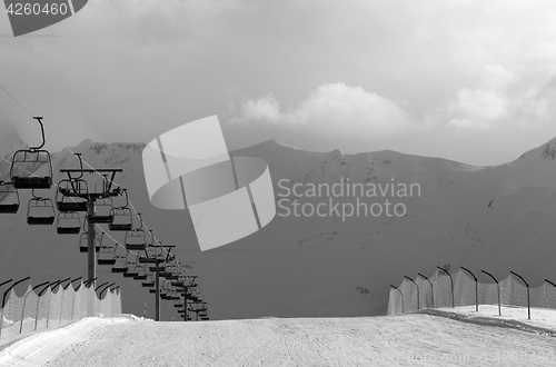 Image of Black and white view on snow skiing piste and ropeway