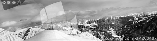 Image of Black and white panorama of off-piste snowy slope and cloudy mou