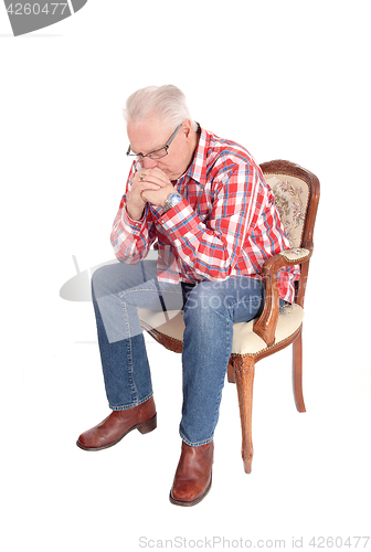 Image of Senior man sitting and thinking.