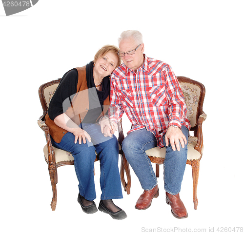 Image of Lovely senior couple in armchair.