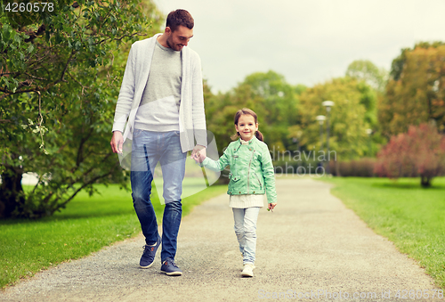 Image of happy family walking in summer park