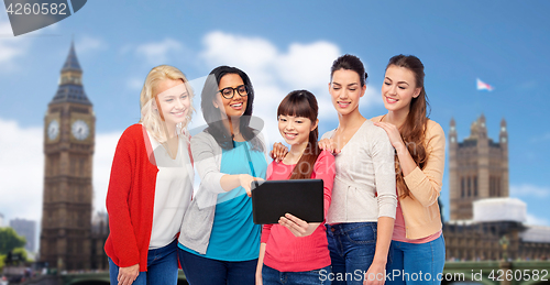 Image of international group of happy women with tablet pc