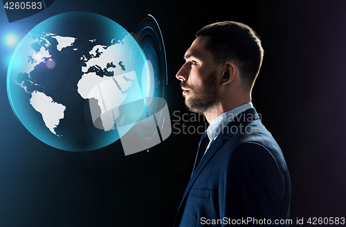 Image of businessman looking at virtual earth projection