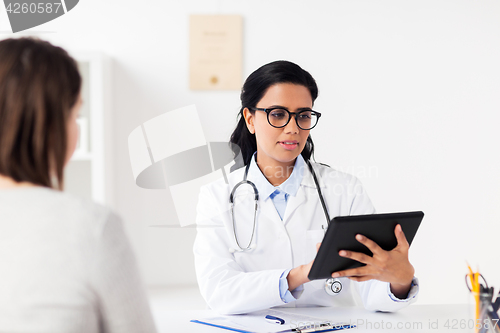 Image of doctor with tablet pc and woman at hospital