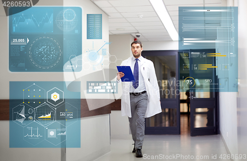 Image of doctor with clipboard walking along hospital