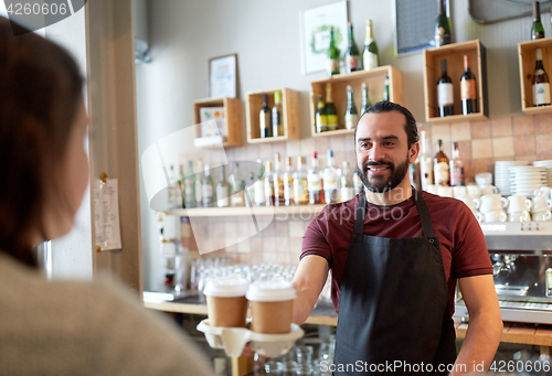 Image of man or waiter serving customer in coffee shop