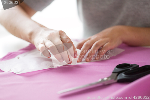 Image of woman with pattern and chalk drawing on fabric