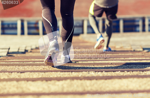 Image of close up of couple running downstairs on stadium