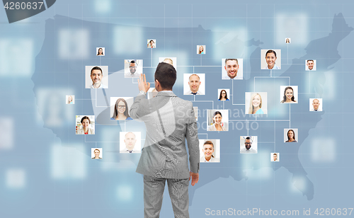 Image of businessman touching virtual screen with contacts