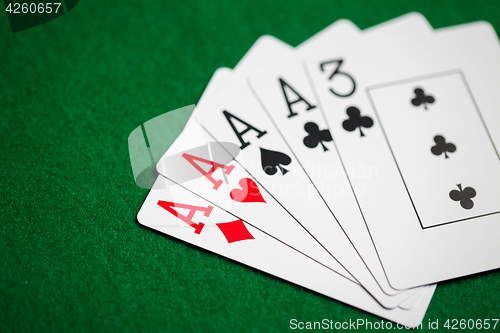 Image of poker hand of playing cards on green casino cloth