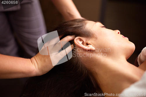 Image of woman having head massage at spa