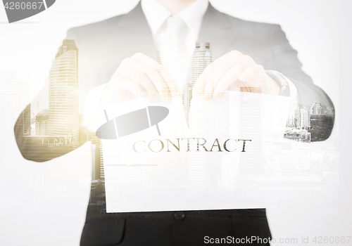 Image of close up of businessman holding contract paper