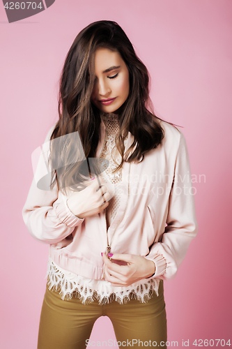 Image of young pretty teenage woman emotional posing on pink background, fashion lifestyle people concept