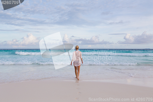 Image of Woman on summer vacations at tropical beach of Mahe Island, Seychelles.