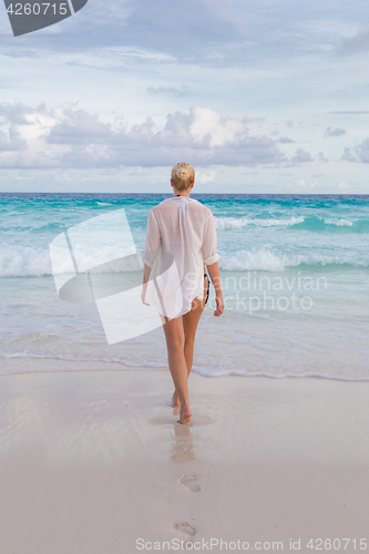 Image of Woman on summer vacations at tropical beach of Mahe Island, Seychelles.