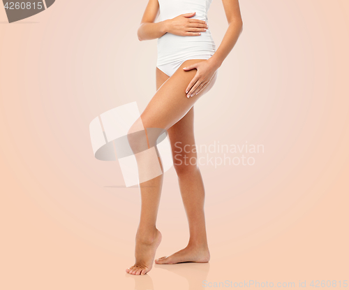 Image of legs of beautiful young woman in white underwear