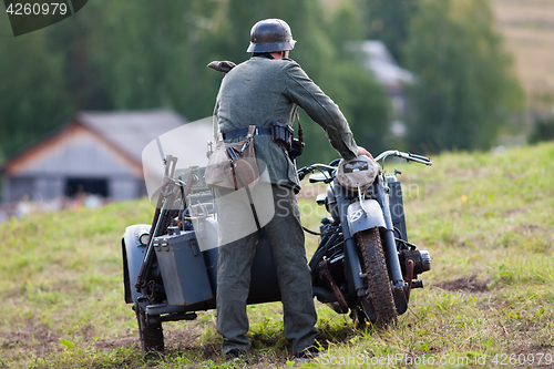 Image of German soldiers of the second world war near the motorbike.