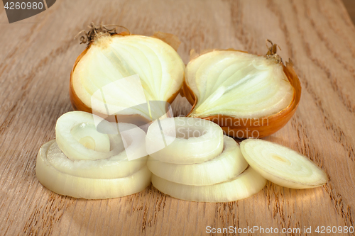 Image of fresh sliced onions on wooden background